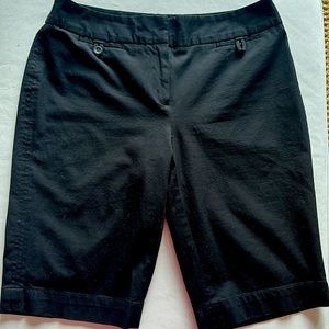 Women’s black stretch walking shorts (no side pockets for slimming effect).